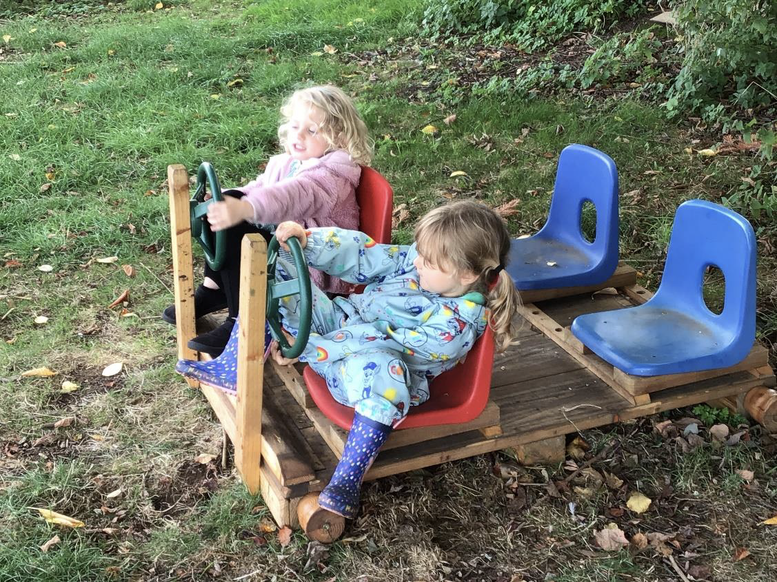 children in pretend car